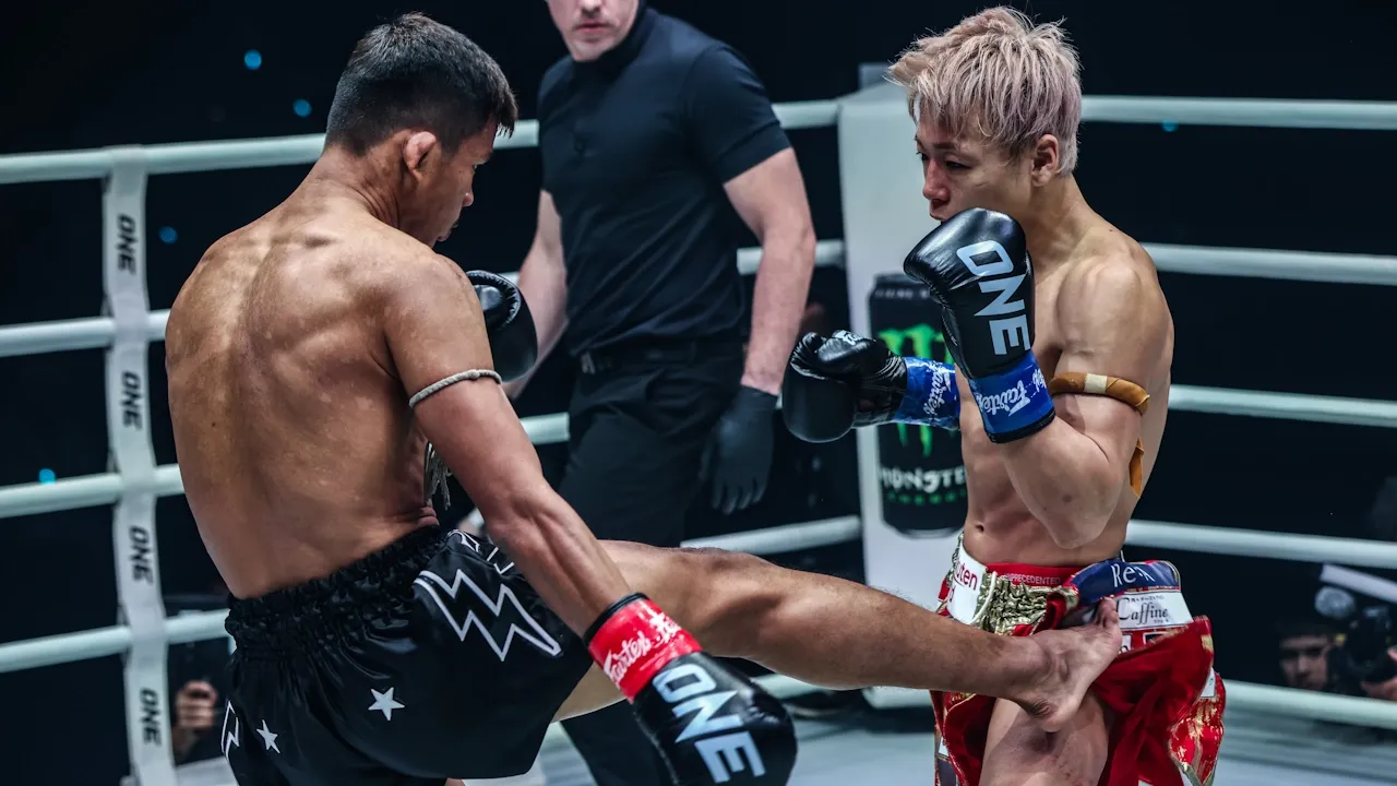 Superlek lands a low kick against Takeru.